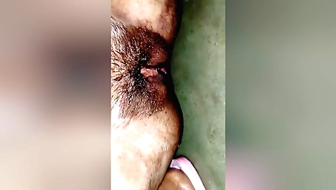 Hairy teen in a white dress fucks in bed in homemade solo