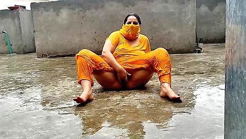 Busty indian brunette enjoys the rain and enjoys it