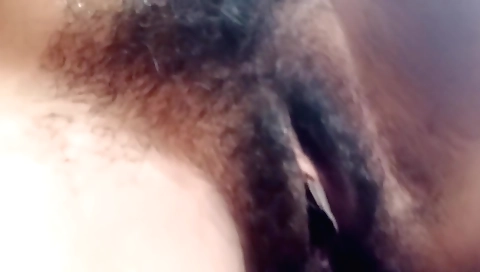 Busty indian girl strips naked and plays with her hairy pussy