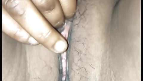 Indian hairy chick masturbates her pussy on the bed in a solo scene